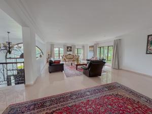 a living room with two couches and a rug at Miyanwe Guest House in Pretoria