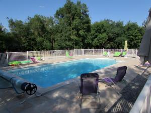 莫雷勒斯Gîte Nénuphar - Gîtes Au Bas Marais的一个带两把草坪椅的游泳池和一个游泳池 更多18张照片
