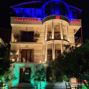 a white building with a blue light on it at Hotel Villa Victoria in Tbilisi City