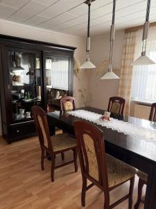 a dining room with a black table and chairs at Ferienhaus in Grevesmühlen