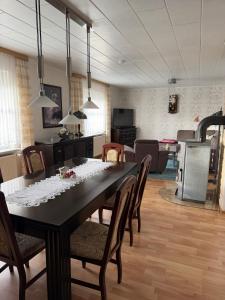 a dining table and chairs in a living room at Ferienhaus in Grevesmühlen +15 photos