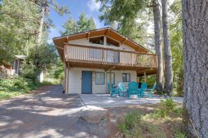 a cabin in the woods with blue chairs and a porch at The Three Bears MCA 901 in Manzanita