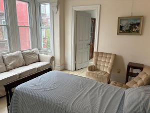 a living room with a bed and a couch at Gilded Age Tower in Philadelphia