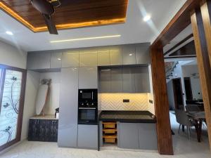 a kitchen with a stove and a microwave at NTH Villa in Udaipur