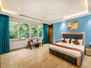 a bedroom with a large bed and blue walls at Villa Vana by DanCenter in Arpora +52 photos