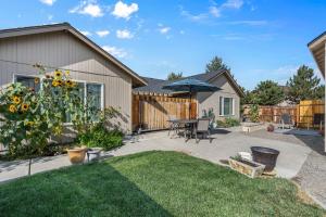 un patio con una mesa y una sombrilla en Scrubjay Suite, en Redmond