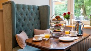 a table with glasses of orange juice and food on it at Schloss Sigrön Tiny Houses in Bad Wilsnack