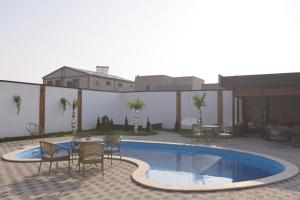 a patio with a table and chairs next to a swimming pool at Davos Hotel in Pʼarakʼar