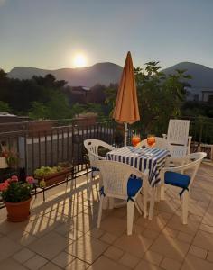 a table with chairs and an umbrella on a patio at Oasi Mondello in Mondello +22 photos