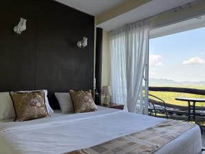 a bedroom with a large bed and a balcony at BaanPhutawanLanta in Ban Mo Nae +13 photos