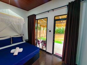 a bedroom with a bed with a cross on it at EMERALD HAVEN SAFARI Cottages in Udawalawe