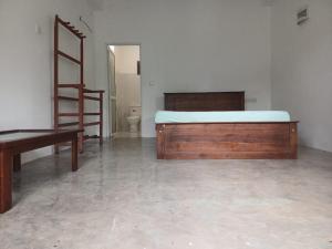 a bedroom with a bed and a desk and a ladder at Villa diamond nest in Unawatuna +28 photos