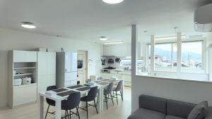 a kitchen and dining room with a table and chairs at 嘉翔の家 in Otsu