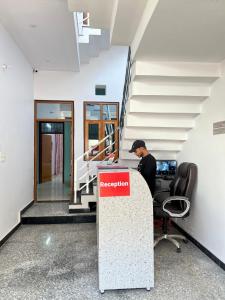 a man sitting at a desk in an office at Hotel Vikrant Inn in Lucknow