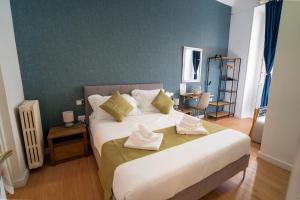 Ένα ή περισσότερα κρεβάτια σε δωμάτιο στο NOI Luxury rooms Colosseum