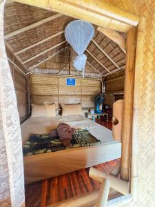 a person is laying on a bed in a room at Baan phuwamin in Ko Lanta