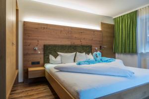 أكتيفهوتيل توكسيرهوف في زيل أم زيلر: غرفة نوم بسرير كبير مع لوح رأس خشبي +121 صورة