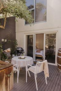 a patio with a table and chairs on a deck at The Waterfront Apartment in Port Fairy