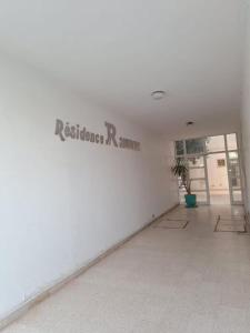 a white room with a sign on the wall at jawhara residency front view in Sousse