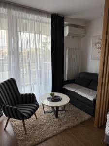 a living room with a couch and a coffee table at Delta SPA Residence in Niš