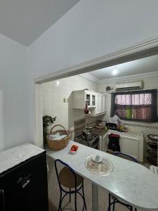 a small kitchen with a table and chairs in it at jawhara residency front view in Sousse
