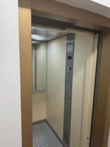 an elevator in a building with a glass door at jawhara residency front view in Sousse