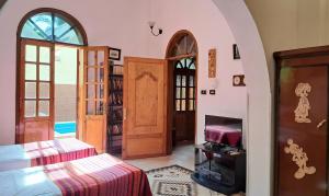 a room with a bed and a room with a door at Villa Belzoni in Luxor