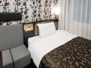 Una cama o camas en una habitación de APA Hotel Shinagawa Togoshi Ekimae