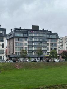 un grand bâtiment avec une enseigne au sommet dans l'établissement Ilidza Suite, à Sarajevo