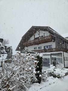 a house covered in snow in front at Gut Kallerbend in Nideggen