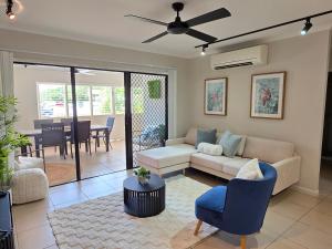 a living room with a couch and a table at Allure at The Edge 3brm luxury apartment with coffee machine and 2 pools! in Cairns North