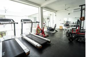 a gym with several treadmills and machines in a room at Serenade Beach Hotel in Hikkaduwa