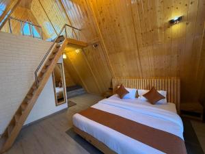 a bedroom with a bed and a staircase in a room at Muskan Mount View Retreat, Mukteshwar in Mukteswar