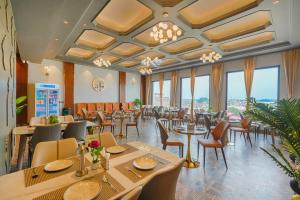 a restaurant with tables and chairs and windows at Hotel Marrion in Amritsar