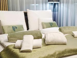 a room with two beds with towels and pillows at Premium Penthouse in Keszthely