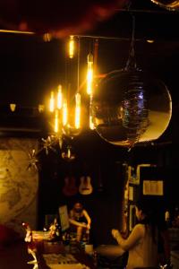 a woman sitting at a bar in a room at Bed Attitude Hostel Cenang in Pantai Cenang
