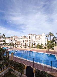 a large swimming pool with buildings in the background at Sonne, Strand und Urlaubsmodus! in Torrevieja