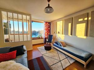 a living room with a couch and a window at Aalto residence in Rovaniemi