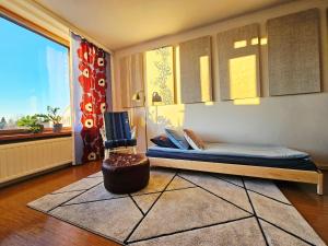 a bedroom with a bed and a chair and a window at Aalto residence in Rovaniemi