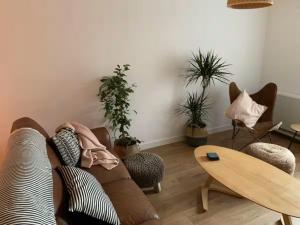 a living room with a couch and a table and plants at Cartref 2 Double Bed Apartment Nebo Dogs Welcome in Amlwch