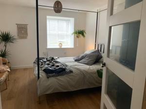 a bedroom with a bed with a four post canopy at Cartref 2 Double Bed Apartment Nebo Dogs Welcome in Amlwch