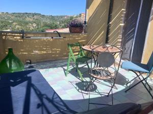a patio with two chairs and a table on a balcony at La Rosa dei Monti Iblei in Ferla +61 photos