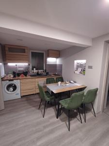 a kitchen and dining room with a table and chairs at Borka-land Vendégház in Deszk