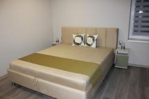 a bedroom with a large bed with two pillows at Borka-land Vendégház in Deszk