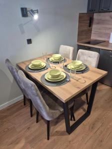 a dining room table with plates and glasses on it at Anđelka in Brzeće +15 photos