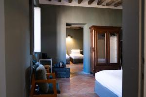 pokój z sypialnią z łóżkiem i lustrem w obiekcie La Locanda di Grazzano Visconti w mieście Grazzano Visconti