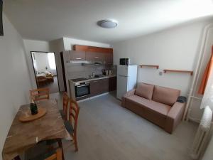 a kitchen and dining room with a table and a couch at Apartmán 254 b in Janske Lazne