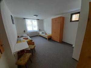 a room with two beds and a table and chairs at Apartmán 254 b in Janske Lazne