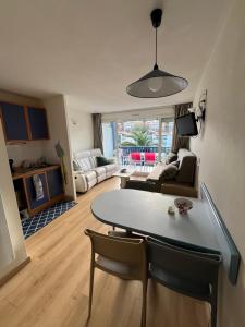 una cucina e un soggiorno con tavolo e sedie di appartement Xiberoa Socoa a Urrugne