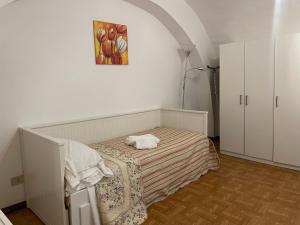 a bedroom with a bed and a painting on the wall at Sogni al Duomo in Catania